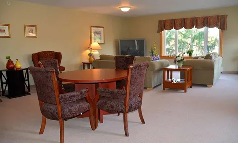 Lounge with round table, armchairs and sofa