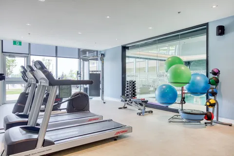Fitness room with treadmills, exercise balls and weight equipment.