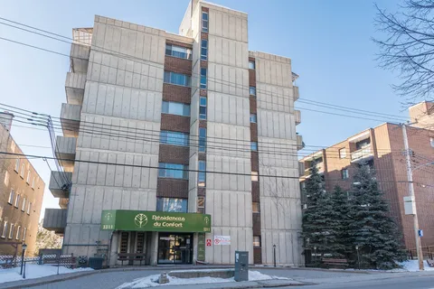 Residence tower and its covered front entrance, seen from across the street.