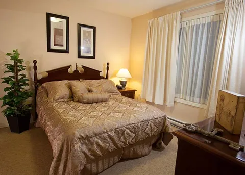 Suite bedroom with a double bed and bedside tables.