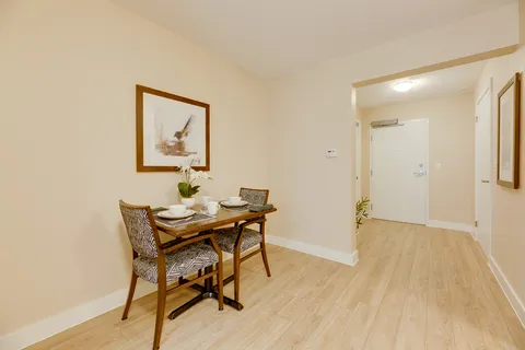 Small dining table and chairs beside a doorway