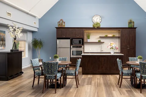 Bistro with tables, chairs, cabinets and beverage appliances.