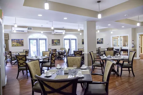 Dining room with set tables, upholstered chairs and pendant lights