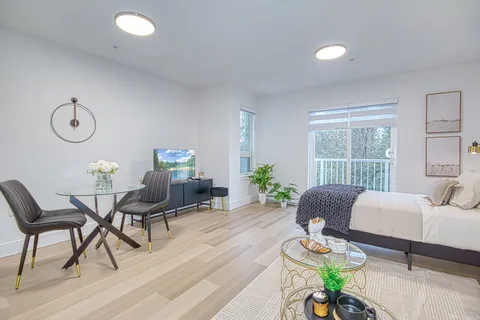 Suite dining and living area with a table, chairs and sofa.