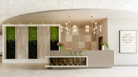 Reception desk beside a living plant wall, flowers and hanging lights