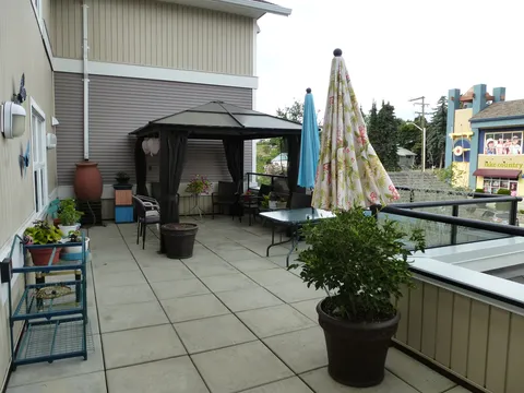 Terrace with planters, a gazebo and patio furniture.