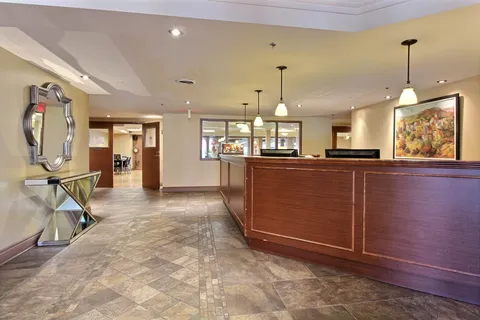 Lobby with a reception desk and tiled flooring.