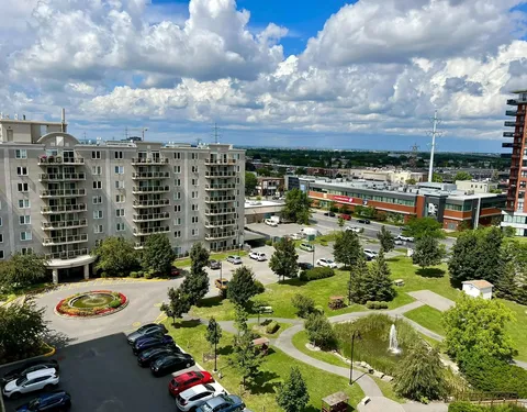 Elevated view of the residence, landscaped grounds and surrounding streets.