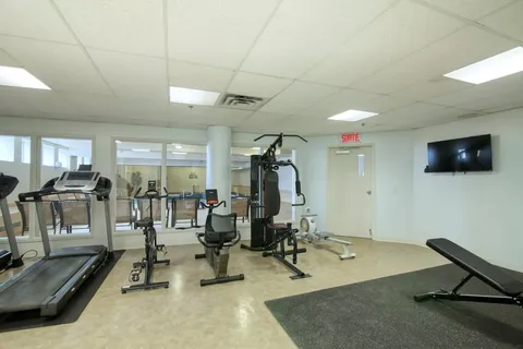 Fitness room with treadmills, exercise bikes and weight equipment.