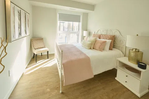 Bedroom with a double bed, bedside table and window.