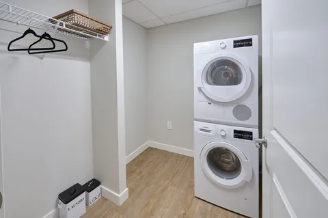 Laundry closet with a stacked washer and dryer.