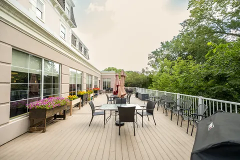 Deck with tables, chairs, umbrellas and flower planters
