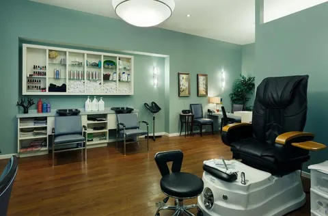 Salon chairs, a foot basin and a cabinet filled with bottles