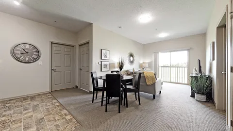Living and dining area with a round table and sliding glass door
