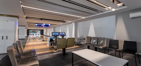 Bowling lanes beside chairs and scoring screens