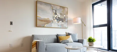 Sofa and small tables beside a large window