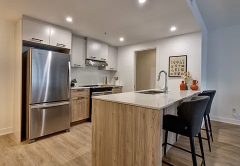 Kitchen with an island, bar stools and stainless-steel appliances