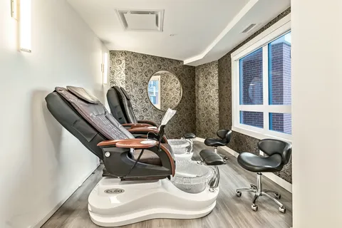 Salon with two pedicure chairs, foot baths and wheeled stools
