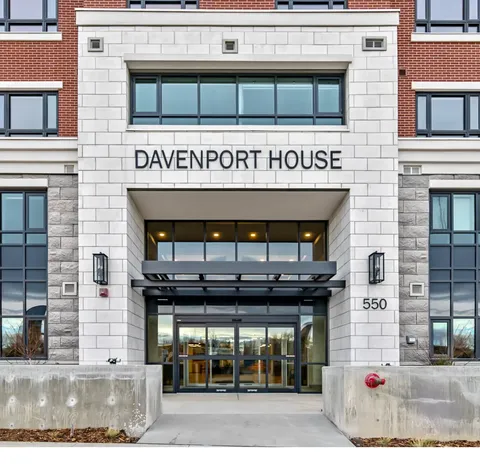 Glass building entrance beneath a stone facade and Davenport House lettering