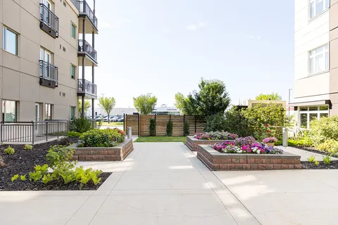 Courtyard path between the residence wings with raised flower beds.