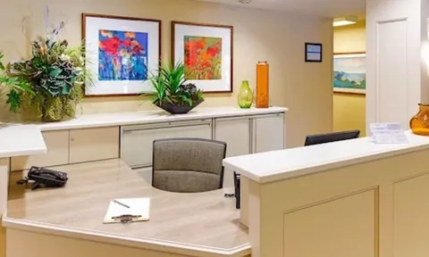 Reception counter with artwork and flower arrangement
