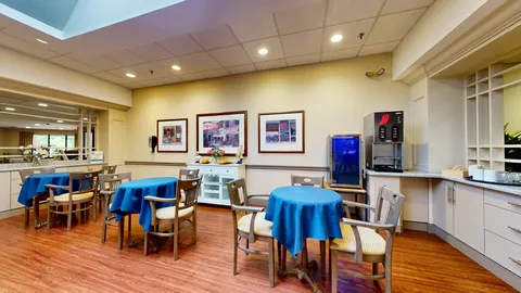 Dining area with blue tablecloths and beverage counter