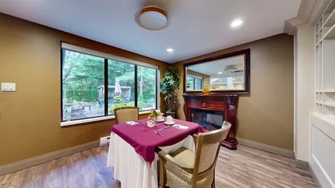 Small dining room with fireplace and garden view