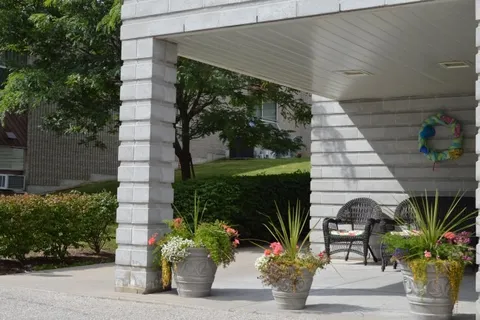 Covered porch with outdoor chairs and potted flowers