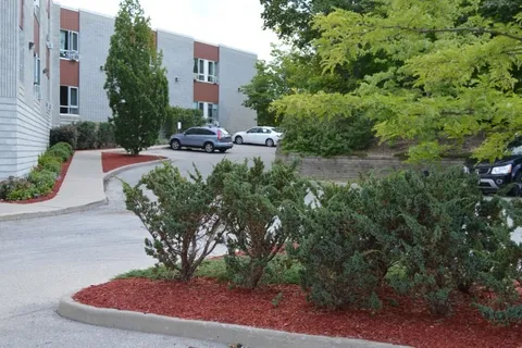 Garden beds and a paved path beside the residence