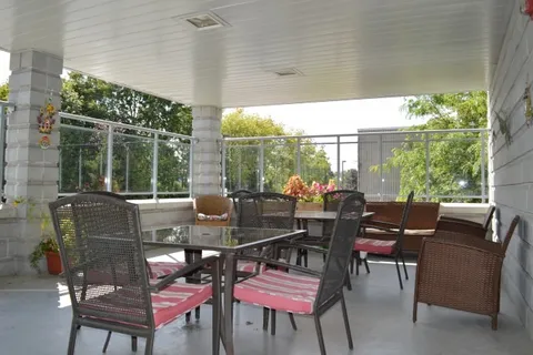 Covered patio with outdoor chairs around a table
