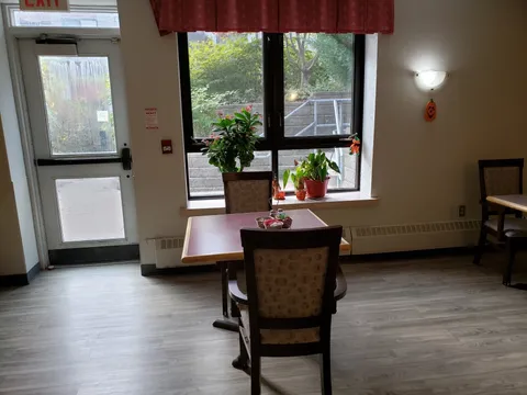 Small table and chairs beside a window and glass exit door