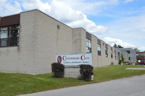 Residence building beside a lawn and a roadside sign