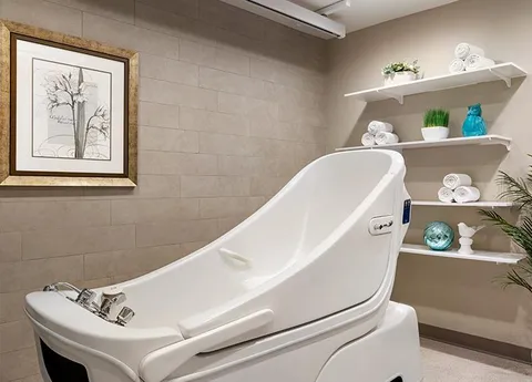 Spa bathroom with an accessible bathtub and shelves.