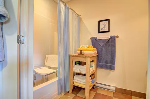 Bathroom with a shower and towel shelf.