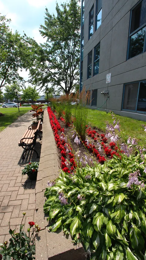 Flower beds and a brick path beside the residence.