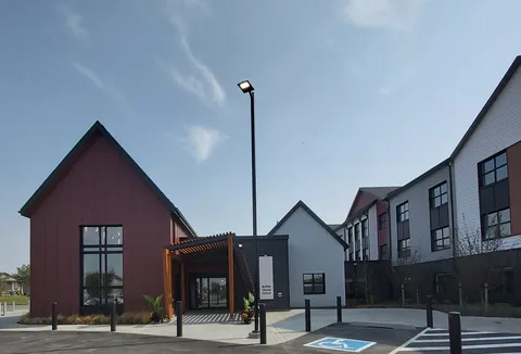 Residence exterior with a covered entrance and paved forecourt