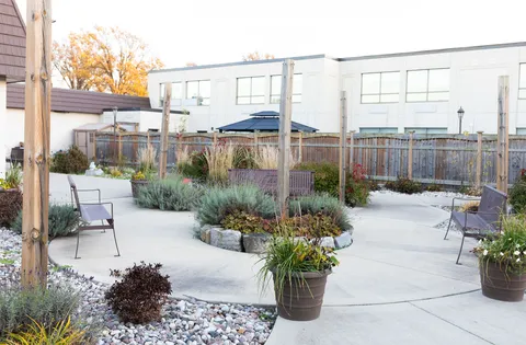 Courtyard with benches, planters, ornamental grasses and paved paths