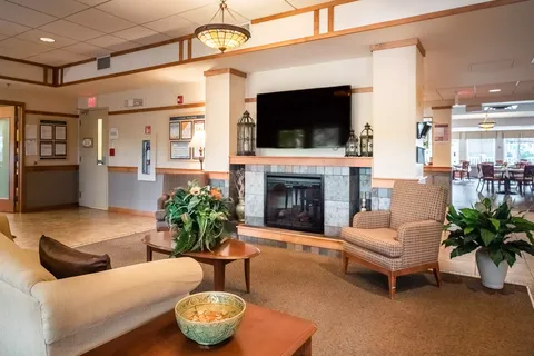 Seating area with a fireplace and blank television