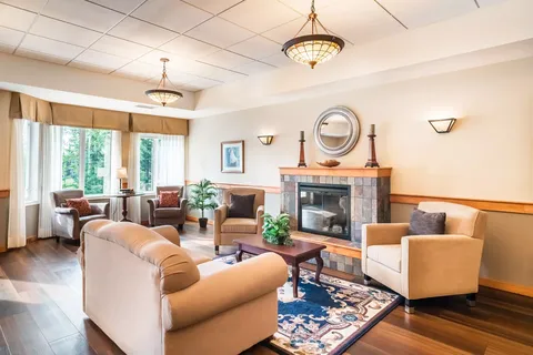 Room with armchairs, a sofa and a stone fireplace
