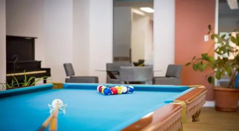 Pool table in an indoor recreation room.