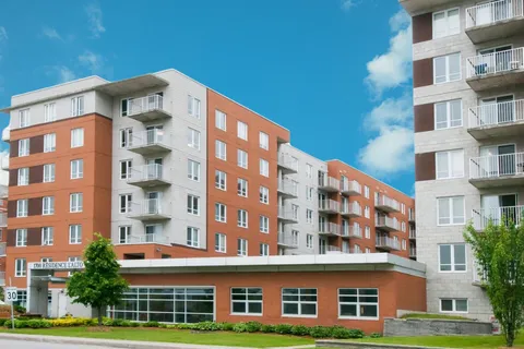 Residence exterior with balconies and a glass-fronted ground floor.