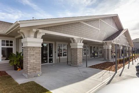 Building with stone porch columns and glass entrance doors