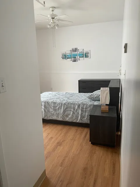 View through a doorway into a bedroom with a single bed