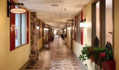 Hallway with stone columns, chairs and wall lights