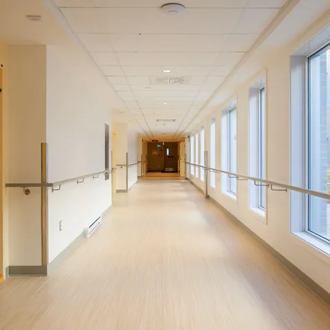 Bright hallway with windows and handrails along both walls