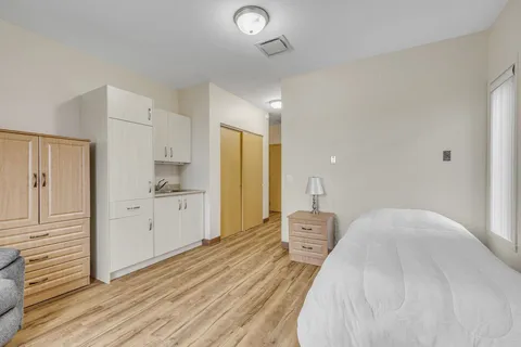 Bedroom with a single bed, bedside cabinet, wardrobe and kitchenette