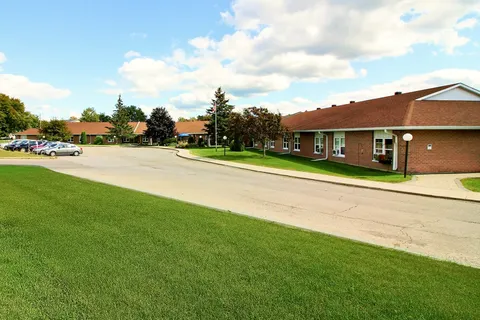 Single-storey brick residence with a lawn and driveway.