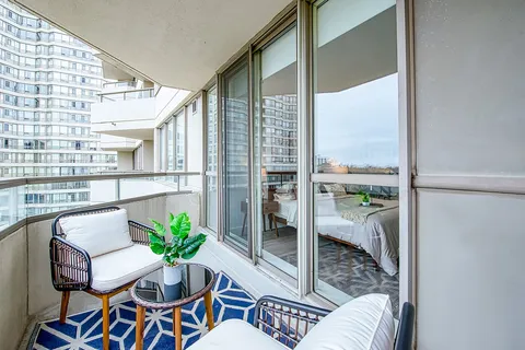 Balcony seating with armchairs beside the suite windows.