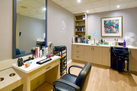 Salon with styling chairs, mirrors and cabinets.