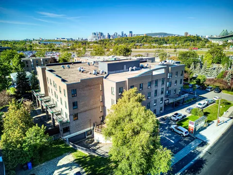 Aerial view of the rear of the residence and surrounding trees.